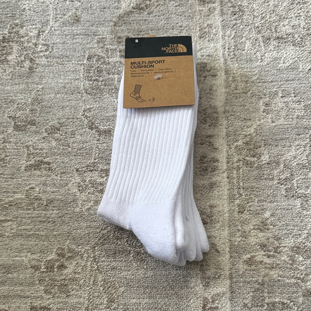 The North Face White Multi-Sport cushion socks. Size Small. Has logo in black.